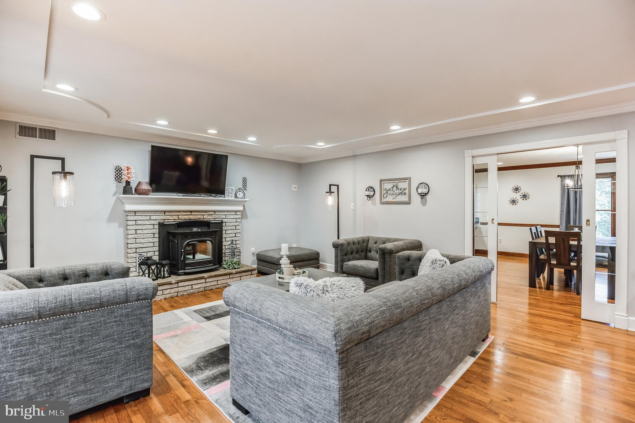 3310 Holland Cliffs Road Huntingtown, MD 20639 - Photo 24 of 40 a living room with furniture a fireplace and a flat screen tv