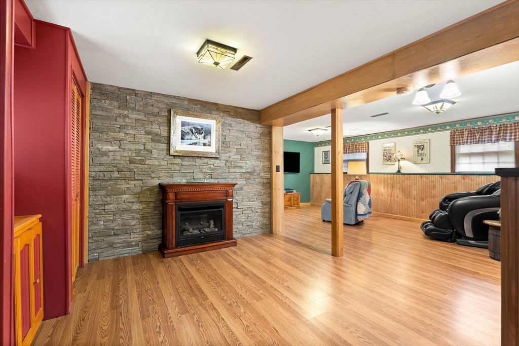 4 Alpha Road Groveland, MA 01834 - Photo 29 of 41 a view of a livingroom with furniture fire place and wooden floor