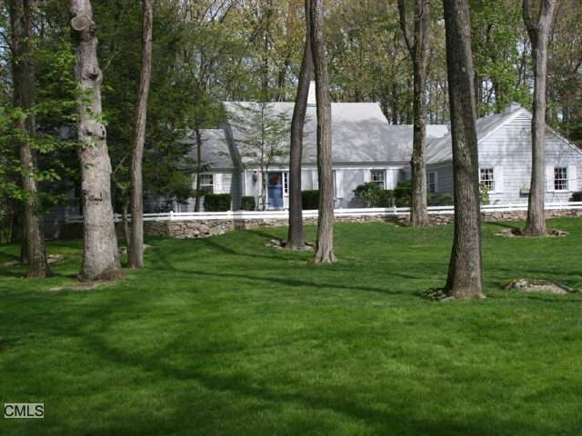 46 Nutmeg Ridge Ridgefield, CT 06877 - Photo 1 of 1 a view of a white house next to a yard with big trees