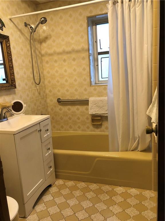 1063 64th Street Brooklyn, NY 11219 - Photo 13 of 20 a bathroom with a bathtub and a shower
