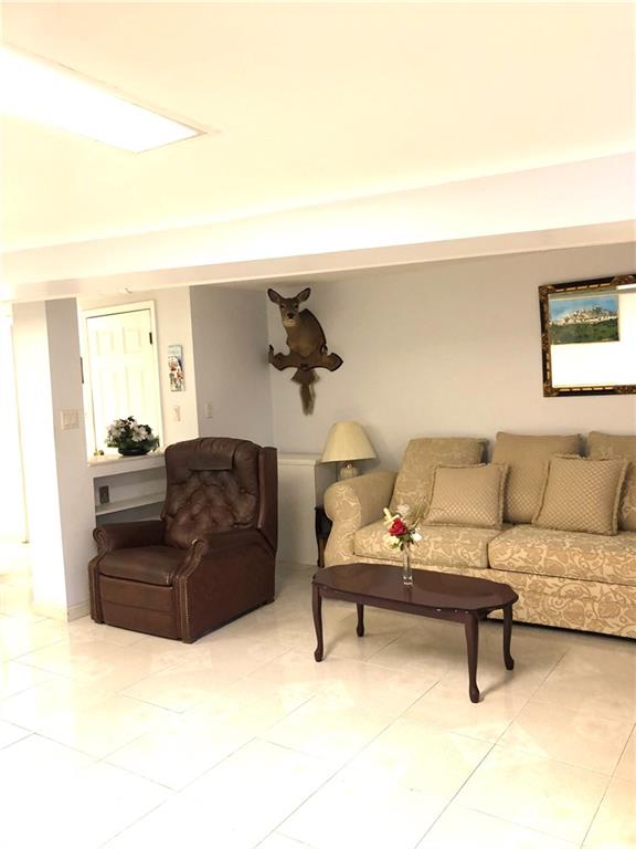 1063 64th Street Brooklyn, NY 11219 - Photo 2 of 20 a living room with furniture and a piano