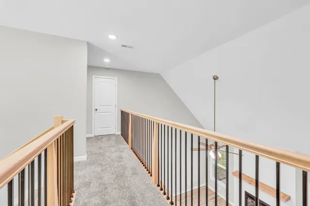 a view of a hallway with stairs