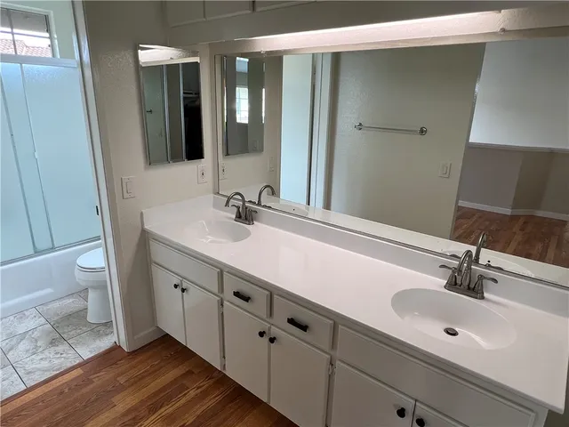 a bathroom with a double vanity sink and a mirror