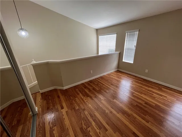 a view of room with window and wooden floor