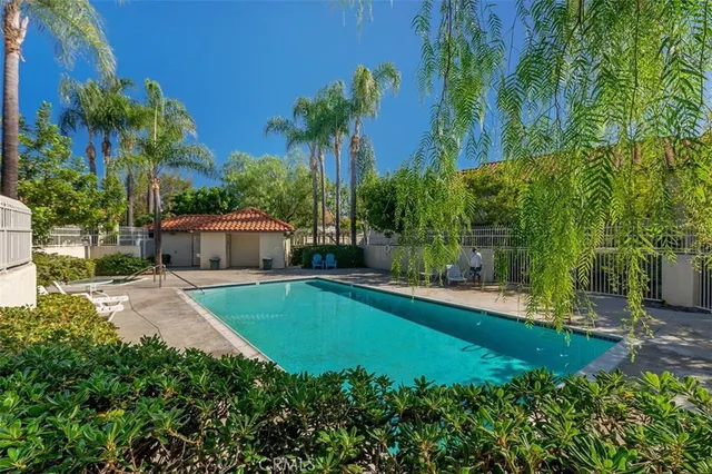 a swimming pool with outdoor seating and yard