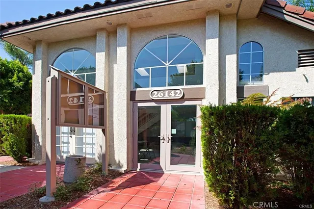 a view of front door and small yard