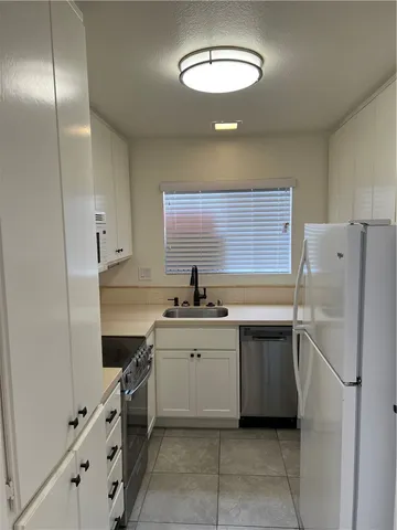 a kitchen with a sink stainless steel appliances and cabinets