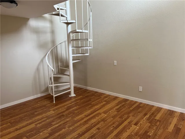 a view of a room with wooden floor and stairs