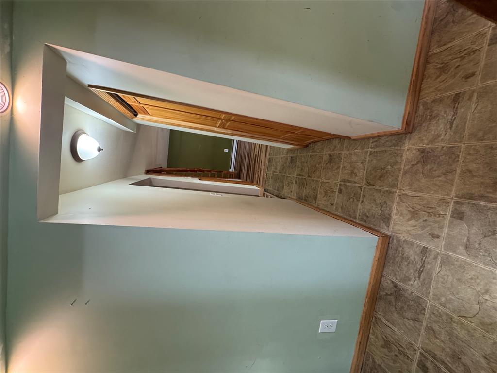 134 Bear Road Kunkletown, PA 18058 - Photo 25 of 42 A tiled hallway connects various living spaces under simple ceiling fixtures.