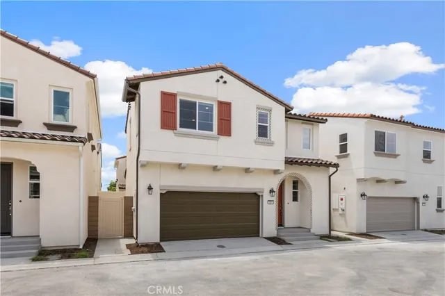 a view of a white house with a garage