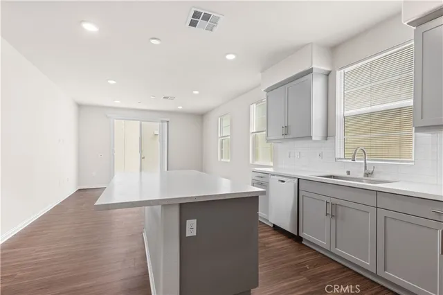 a kitchen with sink cabinets and wooden floor