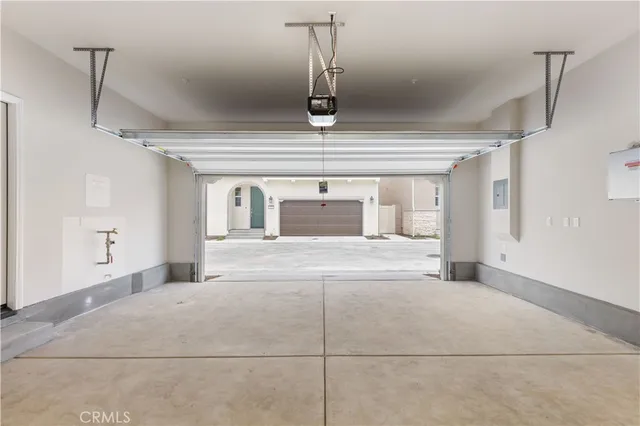 a bedroom with a large bed and chandelier