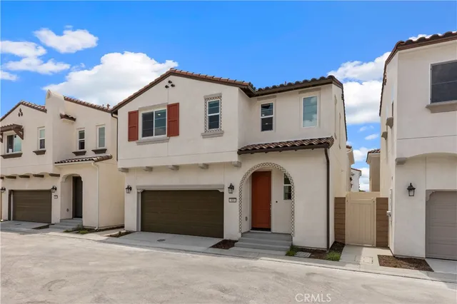 a view of a white house with a garage