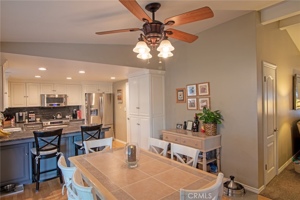 3103 Fish Canyon Road Duarte, CA 91010 - Photo 15 of 20 a room with stainless steel appliances kitchen island granite countertop a table chairs and a refrigerator