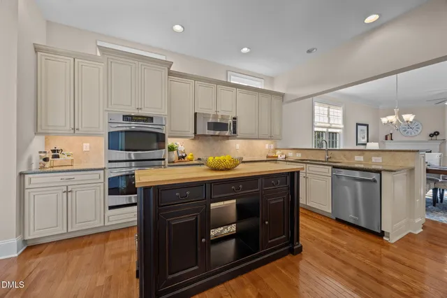 a view of a dining room with furniture wooden floor and chandelier