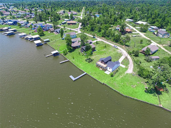 an aerial view of a residential houses with outdoor space and street view