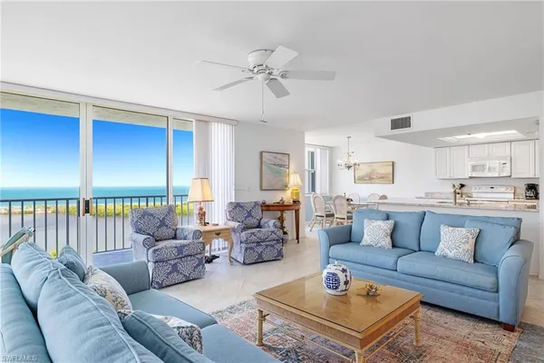 a living room with furniture and a chandelier