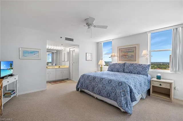 a bedroom with a bed and a view of kitchen