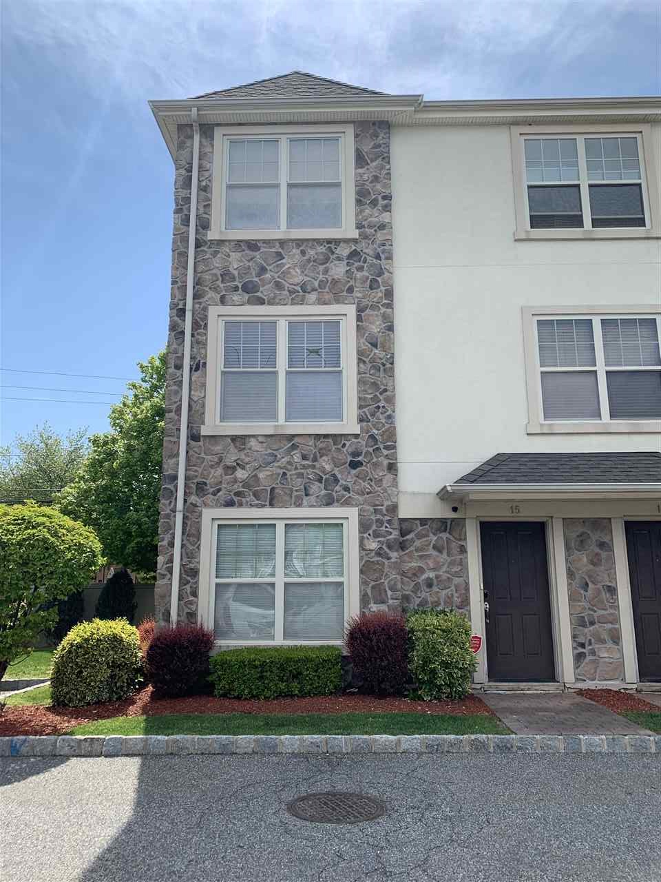 1625 Paterson Plank Road, Unit 15 Secaucus, NJ 07094 - Photo 1 of 1 a front view of a house with a yard and garage