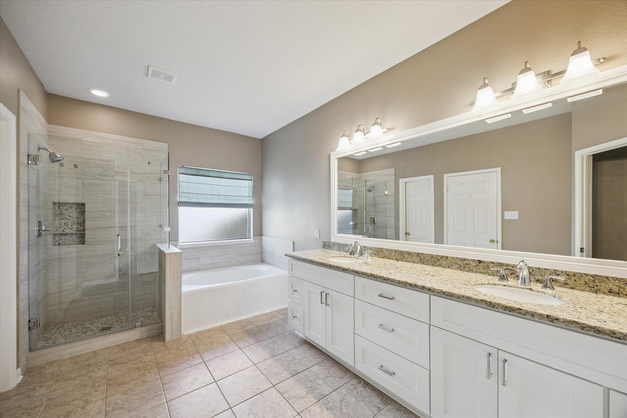 19010 Country Square Drive Houston, TX 77084 - Photo 11 of 23 a spacious bathroom with a granite countertop sink a toilet a mirror and shower