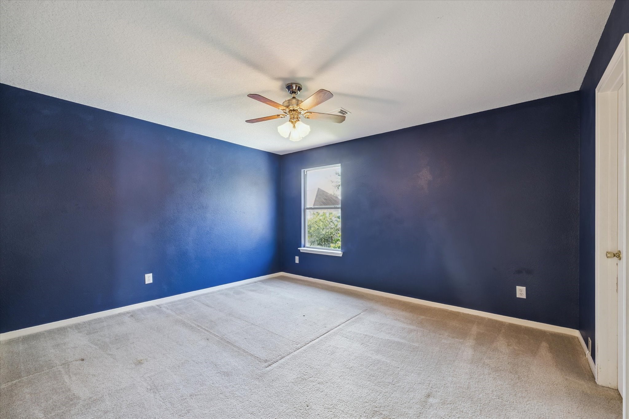 19010 Country Square Drive Houston, TX 77084 - Photo 14 of 23 an empty room with windows and chandelier fan