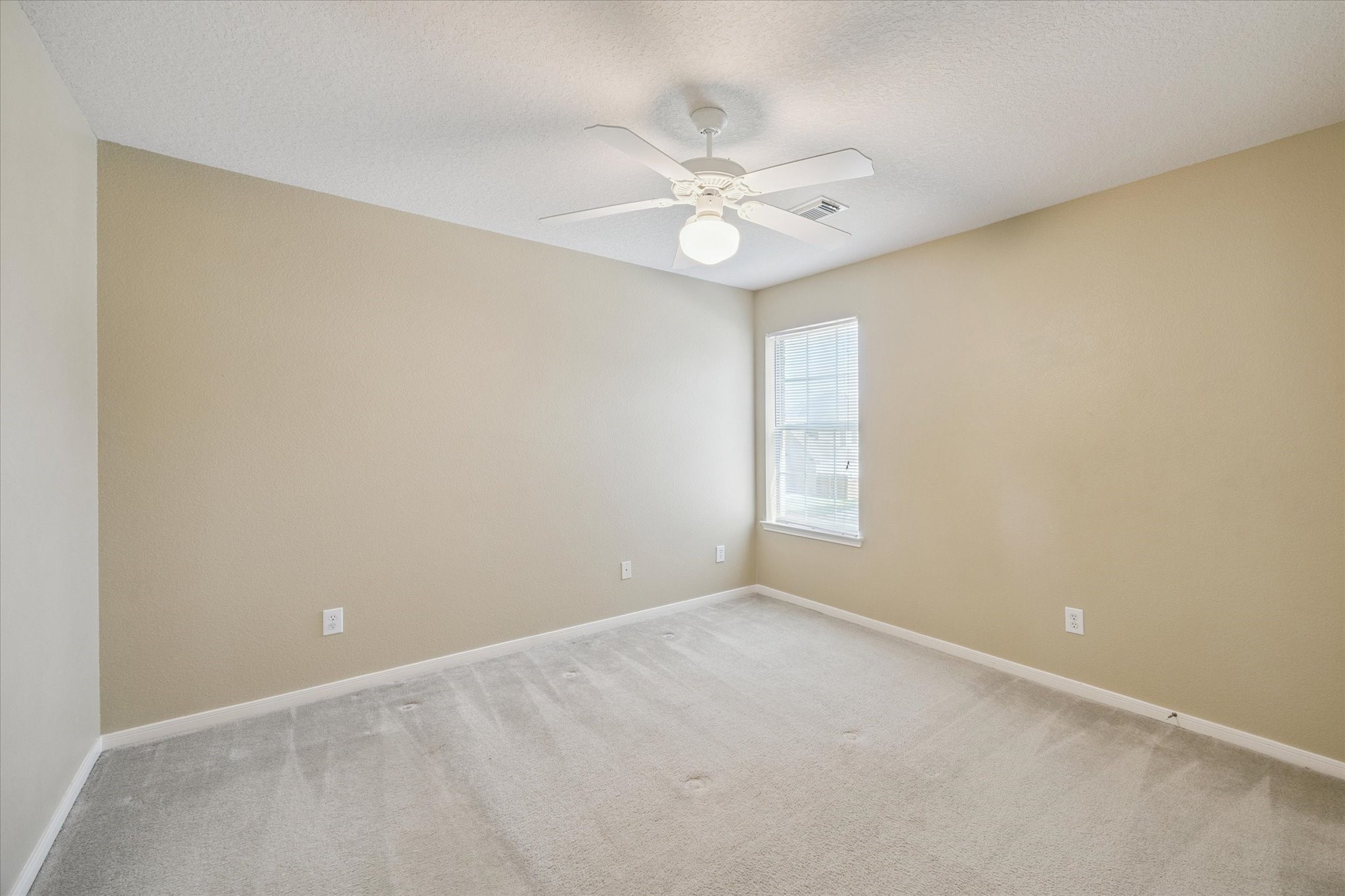 19010 Country Square Drive Houston, TX 77084 - Photo 16 of 23 an empty room with a window and a fan