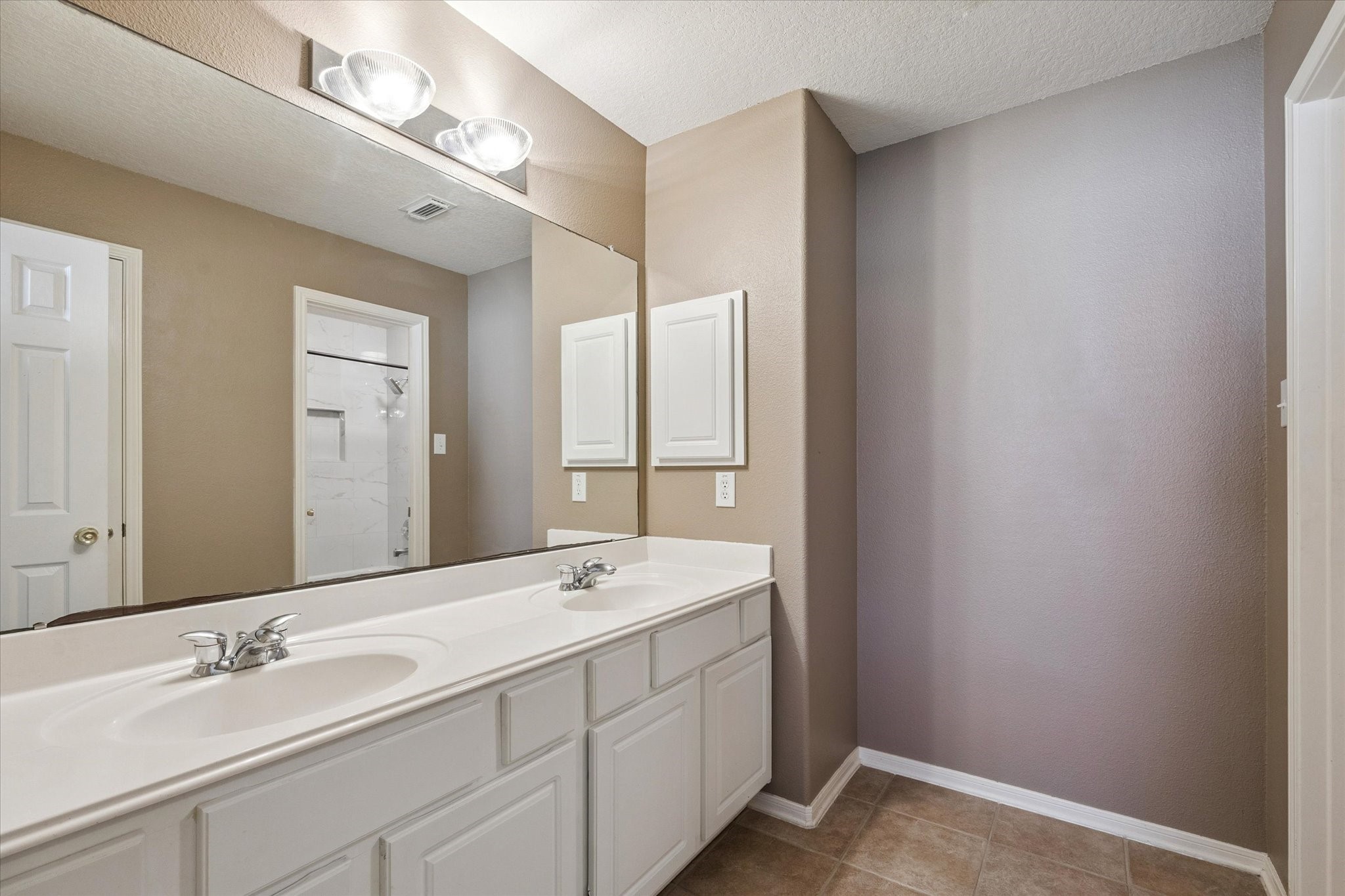 19010 Country Square Drive Houston, TX 77084 - Photo 19 of 23 a bathroom with a double vanity sink and a mirror