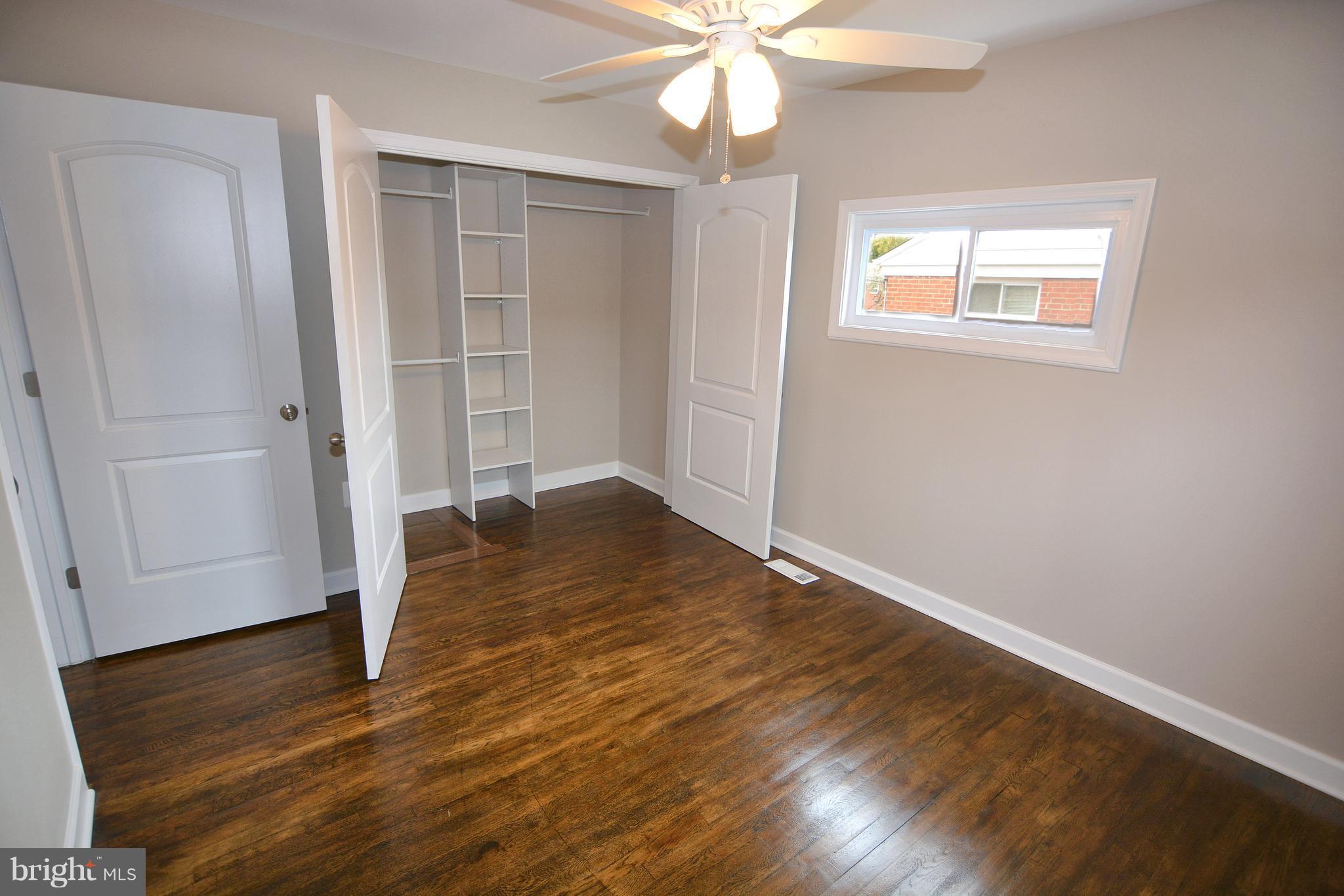 8022 Wallace Road Dundalk, MD 21222 - Photo 14 of 30 wooden floor in an empty room with a window