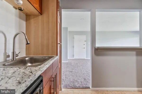 a kitchen with a refrigerator sink and cabinets