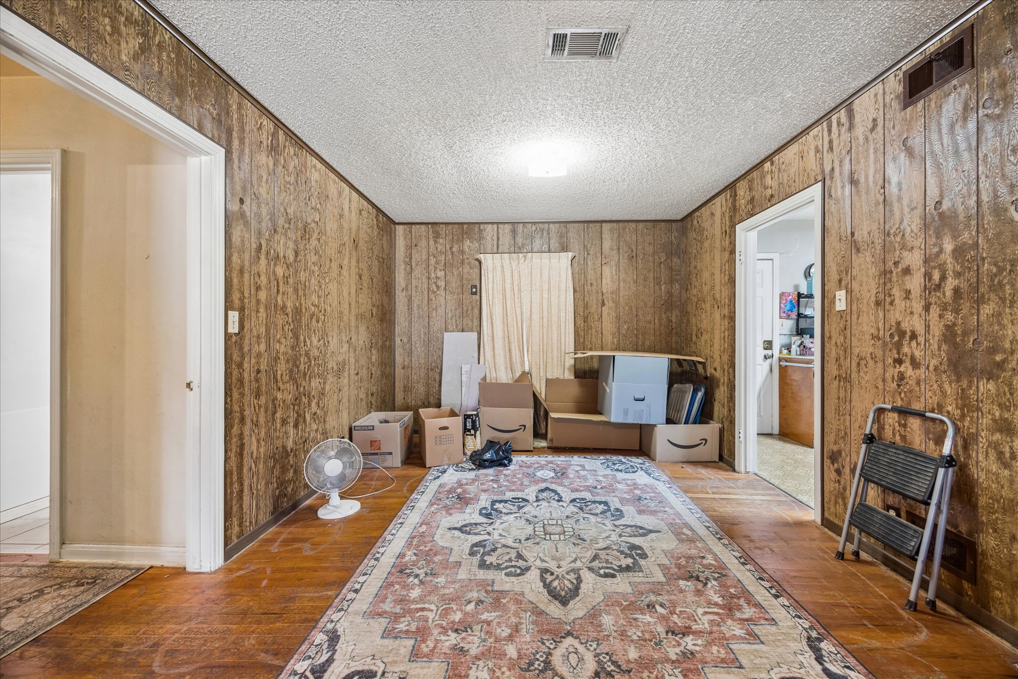 2009 Fort View Road Austin, TX 78704 - Photo 10 of 40 A versatile room, ready for your personalized touch, features natural wood paneling and robust hardwood floors.