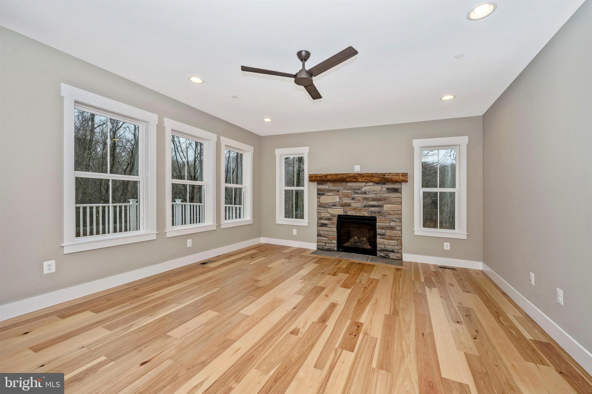 New London Road New Market, MD 21774 - Photo 7 of 68 a view of a livingroom with a fireplace a ceiling fan and windows