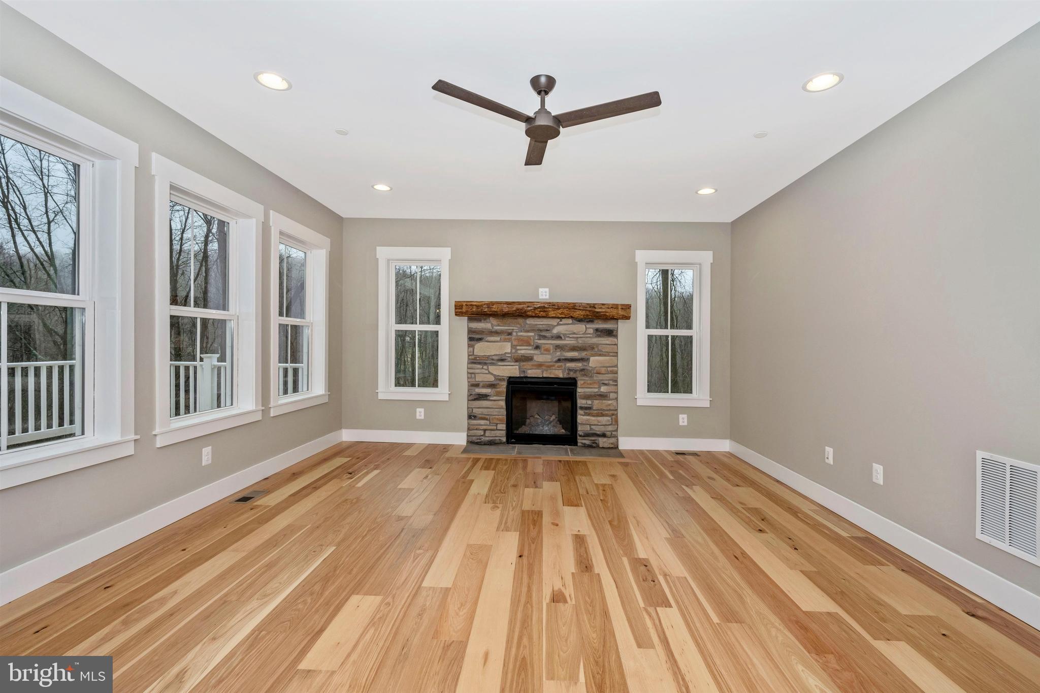 New London Road New Market, MD 21774 - Photo 8 of 68 a view of a livingroom with a fireplace a ceiling fan and windows