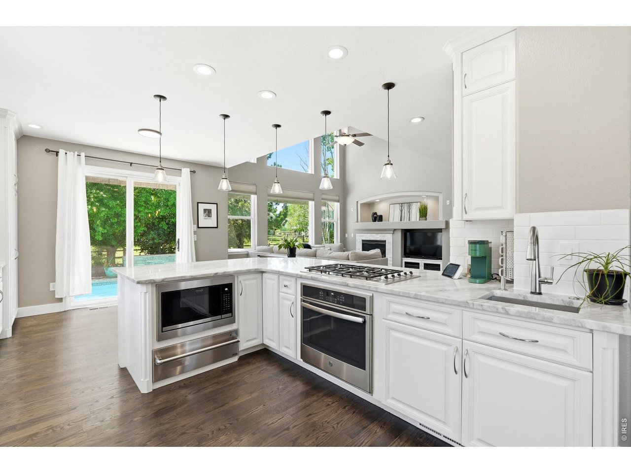 11725 Pleasant Hill Road Longmont, CO 80504 - Photo 13 of 50 Updated counters, fresh paint, subway tile backsplash, stainless steel appliances, modern accent lighting, and ample workspace