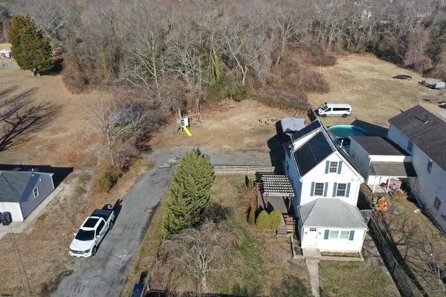 a view of empty room with wooden floor and windows