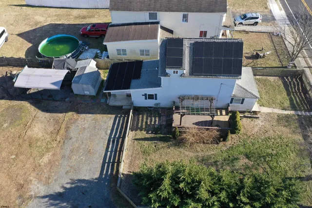 a view of a big room with wooden floor and windows