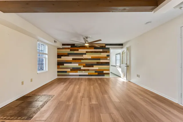 a bathroom with a granite countertop sink and a toilet