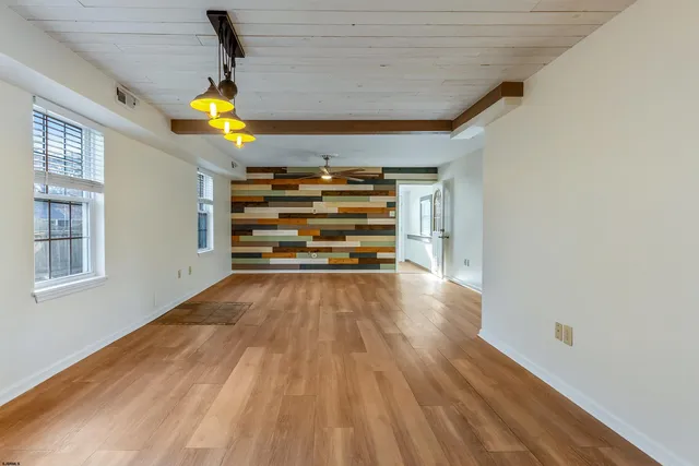 a view of a yard with plants and trees