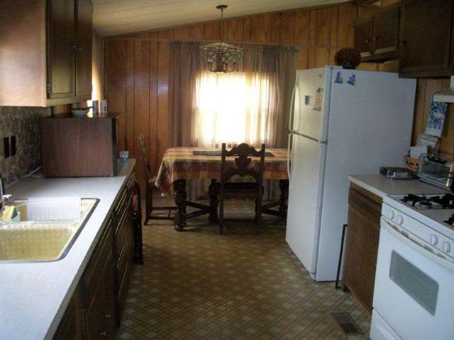 10429 2 Mile Road Thomson, IL 61285 - Photo 6 of 12 a kitchen with refrigerator and window