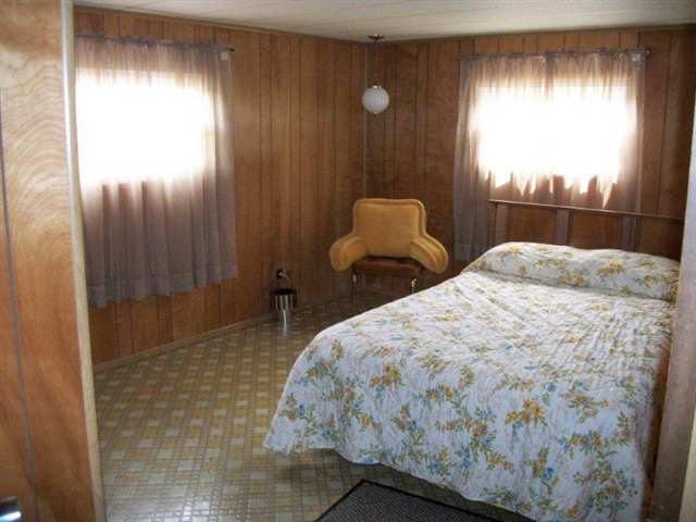 10429 2 Mile Road Thomson, IL 61285 - Photo 9 of 12 a bedroom with a bed and a window