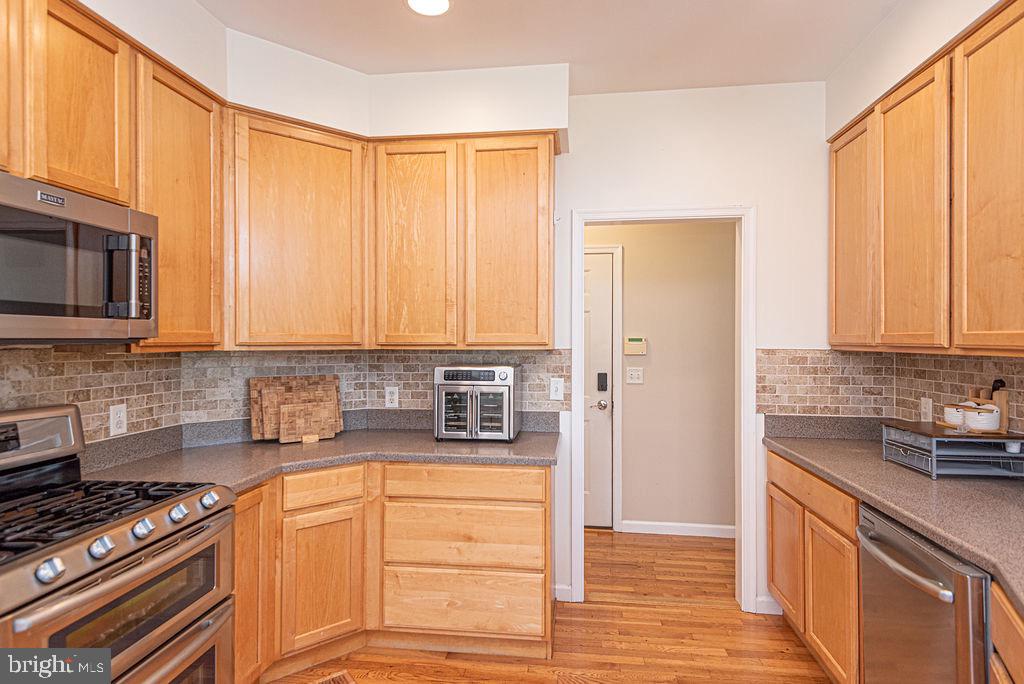 10671 Cathell Road Berlin, MD 21811 - Photo 12 of 63 a kitchen with stainless steel appliances granite countertop a stove a sink and a microwave