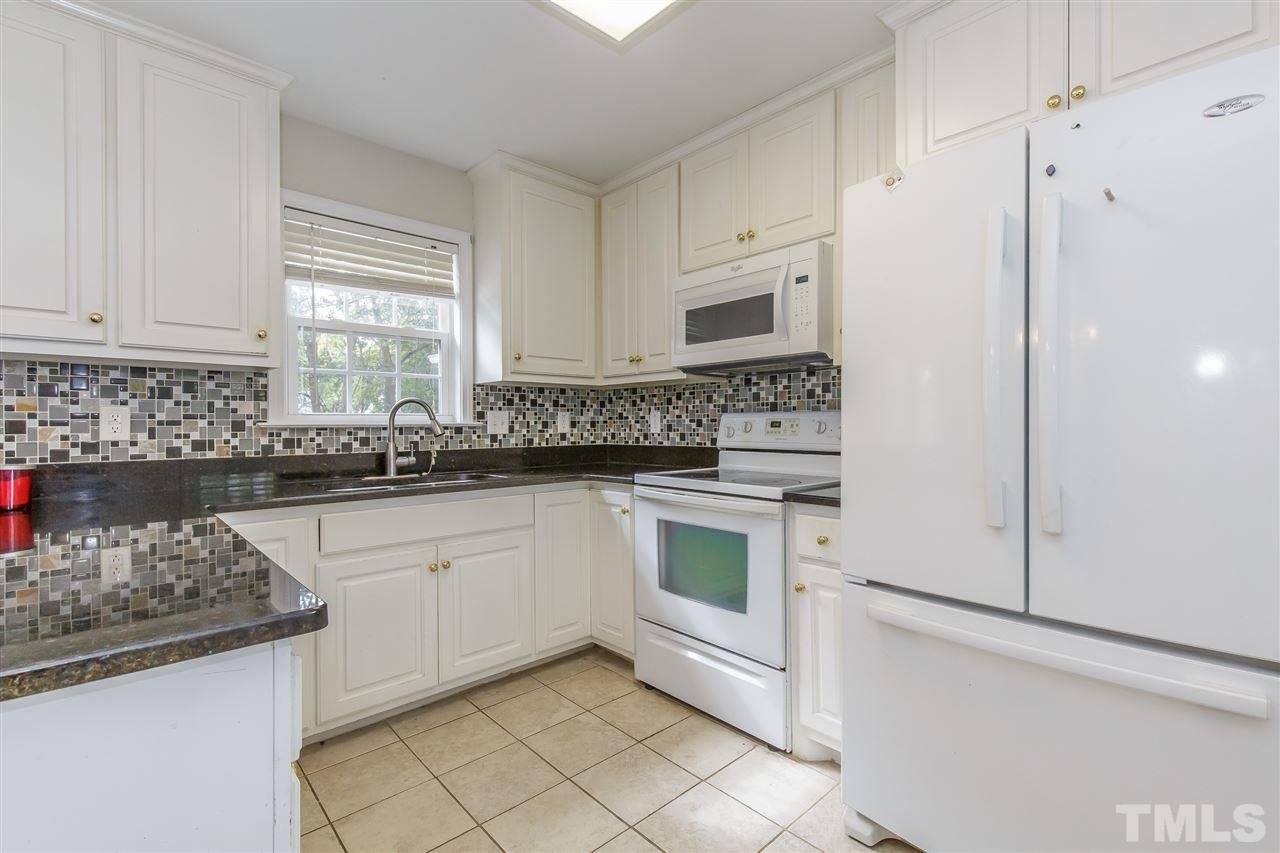 709 Ralph Graham Drive Graham, NC 27253 - Photo 11 of 30 LOVELY crisp white cabinets and appliances with window overlooking rear yard