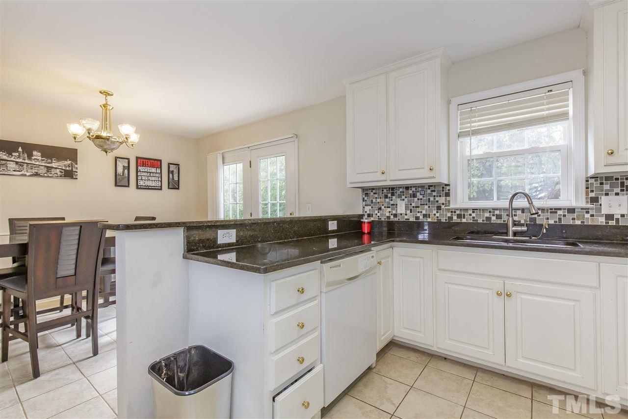 709 Ralph Graham Drive Graham, NC 27253 - Photo 12 of 30 Stunning granite counters and tile backsplash