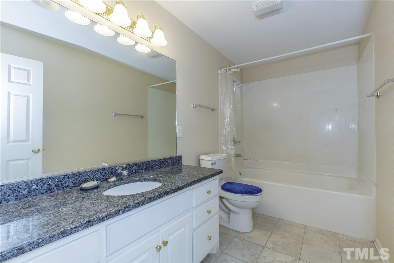 709 Ralph Graham Drive Graham, NC 27253 - Photo 16 of 30 Extended granite vanity, tile floor and shower/tub combination