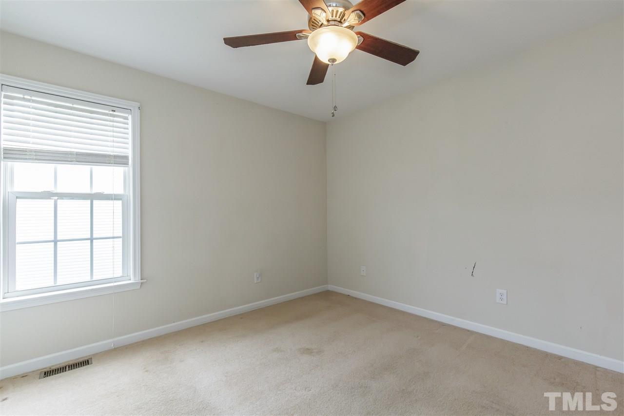 709 Ralph Graham Drive Graham, NC 27253 - Photo 17 of 30 Carpet, fan and window to side yard