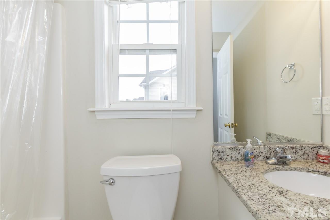 709 Ralph Graham Drive Graham, NC 27253 - Photo 19 of 30 Granite vanity and shower/tub combination