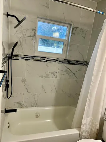 a bathroom with a bathtub and a shower