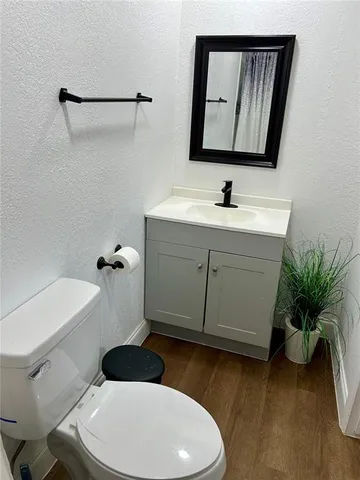 a bathroom with a sink mirror vanity and toilet