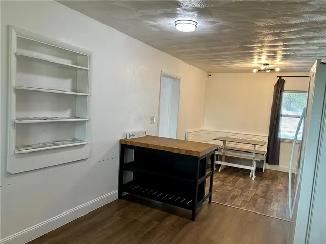 a kitchen with cabinets appliances a sink and a window