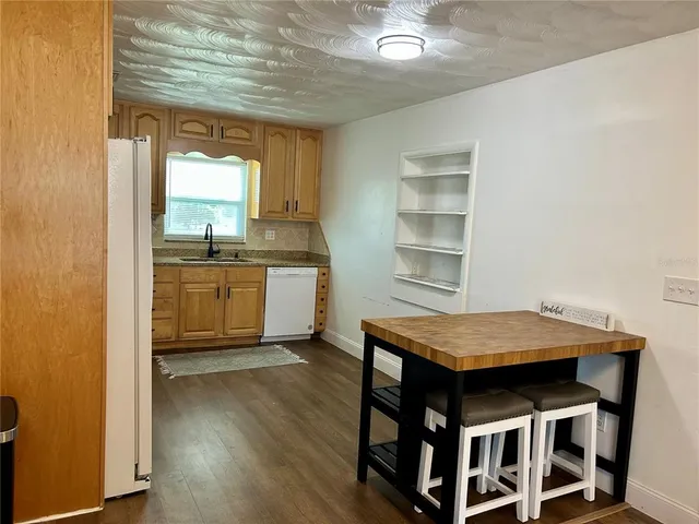 a kitchen with granite countertop cabinets stainless steel appliances and a window
