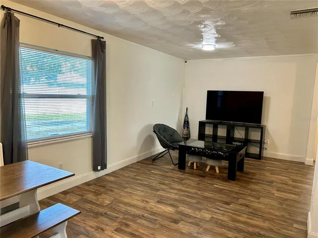 a dining room with furniture and a chandelier